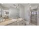 Bright bathroom featuring a shower, quartz counters, a large mirror, and modern fixtures at 2220 Palm Ter, Sarasota, FL 34231