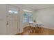 Bright breakfast nook with a white table, modern chairs, hardwood floors, and a window with light-filtering blinds at 2220 Palm Ter, Sarasota, FL 34231