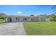 Charming single-story home with a well-manicured lawn and inviting yellow front door at 2220 Palm Ter, Sarasota, FL 34231