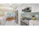 Updated kitchen with stainless steel appliances, modern backsplash, and a cozy breakfast nook at 2220 Palm Ter, Sarasota, FL 34231