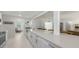 Open kitchen with stainless appliances, a large quartz countertop, and views to the living spaces at 2220 Palm Ter, Sarasota, FL 34231