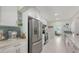 Contemporary kitchen features stainless appliances, tiled backsplash, quartz countertops, and white cabinets at 2220 Palm Ter, Sarasota, FL 34231