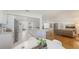 Open-concept living space features light, neutral color scheme, hardwood floors, and a spacious kitchen with island seating at 2220 Palm Ter, Sarasota, FL 34231
