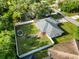 Aerial view showing fenced backyard, green lawn and mature trees surrounding the property at 2272 Palomar St, North Port, FL 34287