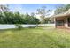 Expansive backyard with lush green grass, mature trees, and a white vinyl fence surrounding the property at 2272 Palomar St, North Port, FL 34287