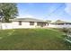 A lush green backyard with a white fence surrounding the property, offering privacy and space at 2272 Palomar St, North Port, FL 34287