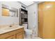 Cozy bathroom featuring a single vanity sink, mirror, built-in shelving, and a toilet at 2272 Palomar St, North Port, FL 34287