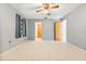 Bedroom with tile flooring, ceiling fan, closet, doors and view into the adjacent room and bathroom at 2272 Palomar St, North Port, FL 34287