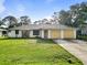 Charming single-story home with a well-maintained lawn, attached two-car garage, and neutral color palette at 2272 Palomar St, North Port, FL 34287