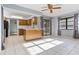 Open concept kitchen with breakfast bar, wooden cabinets, tile flooring, and natural light at 2272 Palomar St, North Port, FL 34287