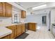Kitchen area with wooden cabinets, stainless steel dishwasher, and white countertop space at 2272 Palomar St, North Port, FL 34287