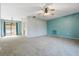 Open living room featuring carpeted floors and natural light from a sliding glass door at 2272 Palomar St, North Port, FL 34287