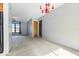 Bright living room featuring carpeted floors, gray walls, a window, and a red chandelier at 2272 Palomar St, North Port, FL 34287