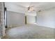 Living room featuring neutral carpet, a ceiling fan, and access to other rooms at 2272 Palomar St, North Port, FL 34287