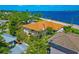 Aerial view of the property highlighting its location, brown roof, lush landscaping, and neighborhood at 2305 Riverview Blvd, Bradenton, FL 34205
