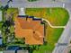 Drone's-eye view of house featuring a brown roof, manicured lawn, and picturesque walkway at 2305 Riverview Blvd, Bradenton, FL 34205