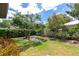 Lush backyard features green grass, mature trees, and privacy hedges at 2305 Riverview Blvd, Bradenton, FL 34205