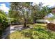 Lush backyard features mature trees, green grass, and patio area at 2305 Riverview Blvd, Bradenton, FL 34205