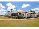 Lovely single-story home featuring a spacious screened lanai, lush landscaping, and charming walkway at 2305 Riverview Blvd, Bradenton, FL 34205