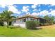 Beautiful home with a well-maintained lawn, lush landscaping, and charming architecture at 2305 Riverview Blvd, Bradenton, FL 34205