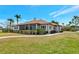 Charming home features a screened porch, manicured lawn, and beautiful landscaping at 2305 Riverview Blvd, Bradenton, FL 34205