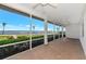 Spacious screened porch with brick flooring, ceiling fans, and beautiful water views at 2305 Riverview Blvd, Bradenton, FL 34205