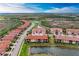 An aerial view shows stunning homes surrounded by lush landscapes and winding waterways in a vibrant community at 23261 Banbury Way # 501, Venice, FL 34293