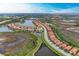 Panoramic aerial view of community with lakes, lush landscaping, and convenient access to highways at 23261 Banbury Way # 501, Venice, FL 34293