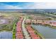 Community aerial view highlighting lakefront property, meticulously maintained landscaping, and proximity to highways at 23261 Banbury Way # 501, Venice, FL 34293