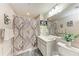 Bathroom with shower and tub, patterned curtain, and decor at 23261 Banbury Way # 501, Venice, FL 34293
