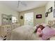 Bedroom with a queen bed, floral pillows, and floral decor at 23261 Banbury Way # 501, Venice, FL 34293