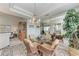 Lovely dining area with glass table, wicker chairs, and views into the living space at 23261 Banbury Way # 501, Venice, FL 34293