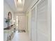 Bright foyer features a console table, closet, and neutral tile flooring at 23261 Banbury Way # 501, Venice, FL 34293