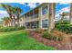 Exterior of the building from the garden, screened lanais visible on both levels at 23261 Banbury Way # 501, Venice, FL 34293