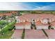 Exterior elevation showcases a beautiful three-story townhome with a paved driveway and well-manicured landscaping at 23261 Banbury Way # 501, Venice, FL 34293