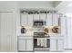 Kitchen with white cabinets and tiled backsplash at 23261 Banbury Way # 501, Venice, FL 34293
