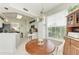 Inviting breakfast nook with white cabinets and modern lighting next to the kitchen space at 23261 Banbury Way # 501, Venice, FL 34293
