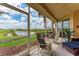 Relaxing screened lanai offers beautiful water views, perfect for outdoor enjoyment at 23261 Banbury Way # 501, Venice, FL 34293