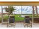 Screened lanai with scenic views of the lake and community landscape beyond at 23261 Banbury Way # 501, Venice, FL 34293
