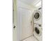 Convenient laundry area with stacked washer and dryer near the entry door at 23261 Banbury Way # 501, Venice, FL 34293