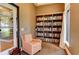 Cozy library nook with built-in bookshelves, a comfortable chair, and ample natural light at 23261 Banbury Way # 501, Venice, FL 34293