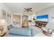 Inviting living room with comfortable seating, ceiling fan, and access to balcony at 23261 Banbury Way # 501, Venice, FL 34293