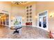 Elegant community lobby with tile floors, a chandelier, and entryways to dining and lounge areas at 23261 Banbury Way # 501, Venice, FL 34293