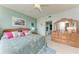 Serene bedroom featuring a queen-sized bed, decorative pillows, and a natural light-filled view of the ensuite bathroom at 23261 Banbury Way # 501, Venice, FL 34293