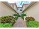 A picturesque brick pathway leads to the entrance, framed by lush, manicured landscaping at 23261 Banbury Way # 501, Venice, FL 34293