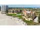 Aerial view of condos on a beach near a golf course and clubhouse overlooking the ocean at 2333 Gulf Of Mexico Dr # 1A2, Longboat Key, FL 34228