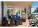 Inviting balcony with cozy outdoor seating and scenic views of the beach and tropical landscape at 2333 Gulf Of Mexico Dr # 1A2, Longboat Key, FL 34228