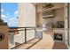 Exterior balcony with outdoor kitchen and grill overlooks ocean and beach at 2333 Gulf Of Mexico Dr # 1A2, Longboat Key, FL 34228
