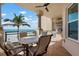 Outdoor kitchen with built in BBQ and bar overlooks the beach with tile flooring and ceiling fan at 2333 Gulf Of Mexico Dr # 1A2, Longboat Key, FL 34228