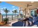 Elegant balcony features outdoor seating and grill with panoramic views of the beach and ocean at 2333 Gulf Of Mexico Dr # 1A2, Longboat Key, FL 34228